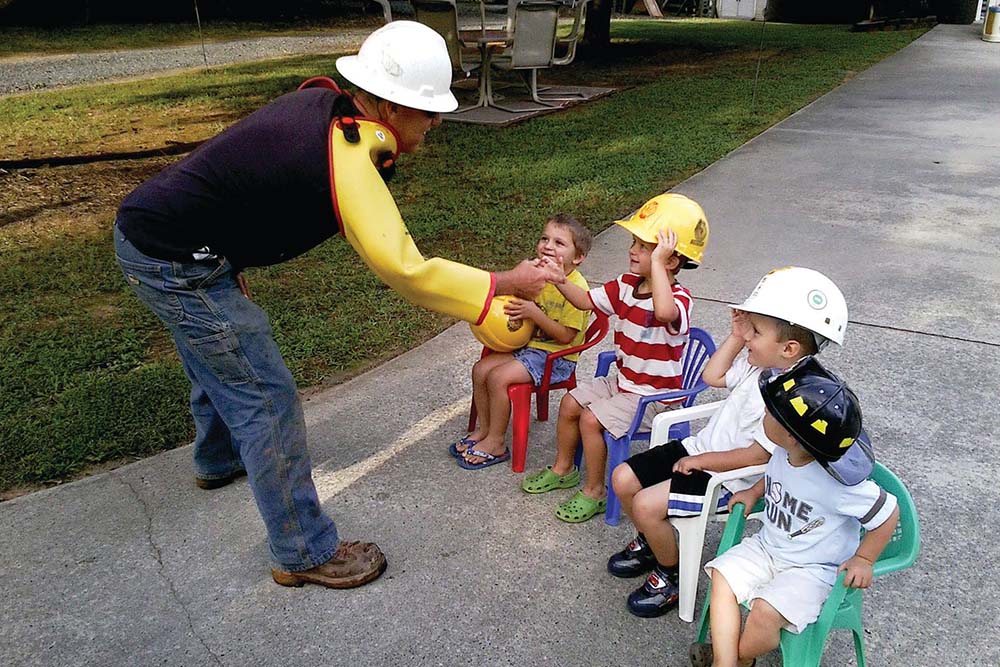 linemen shaking hands with children