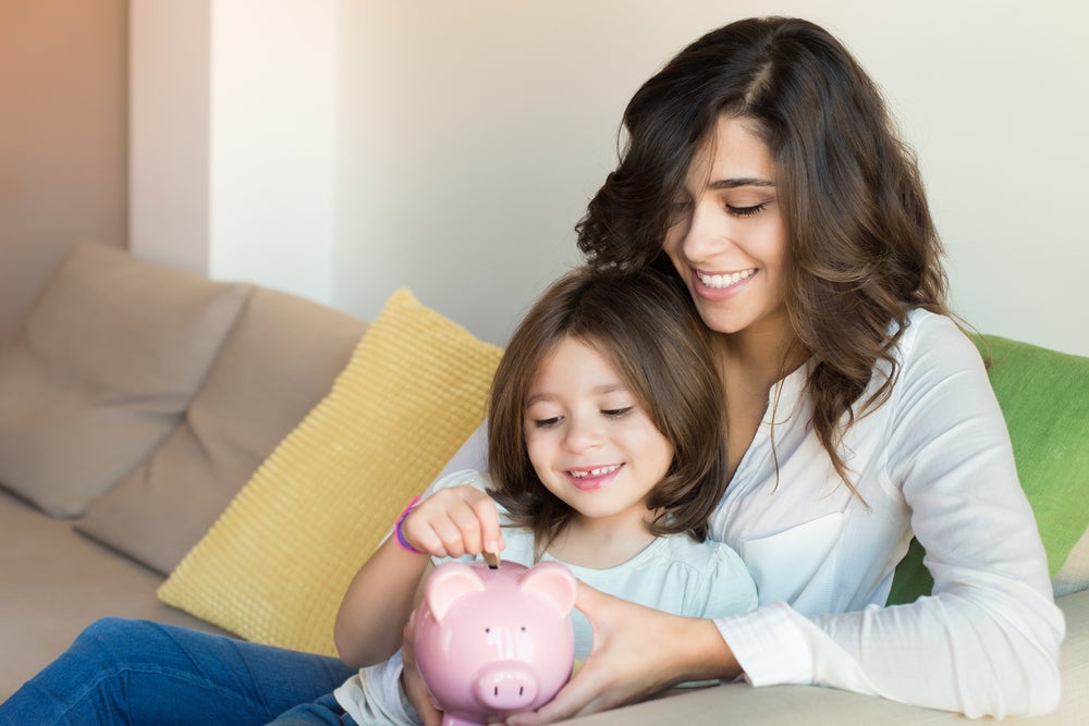 woman & daughter with piggy bank