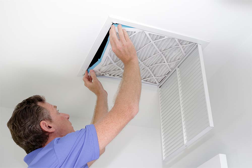Man changing out air filter