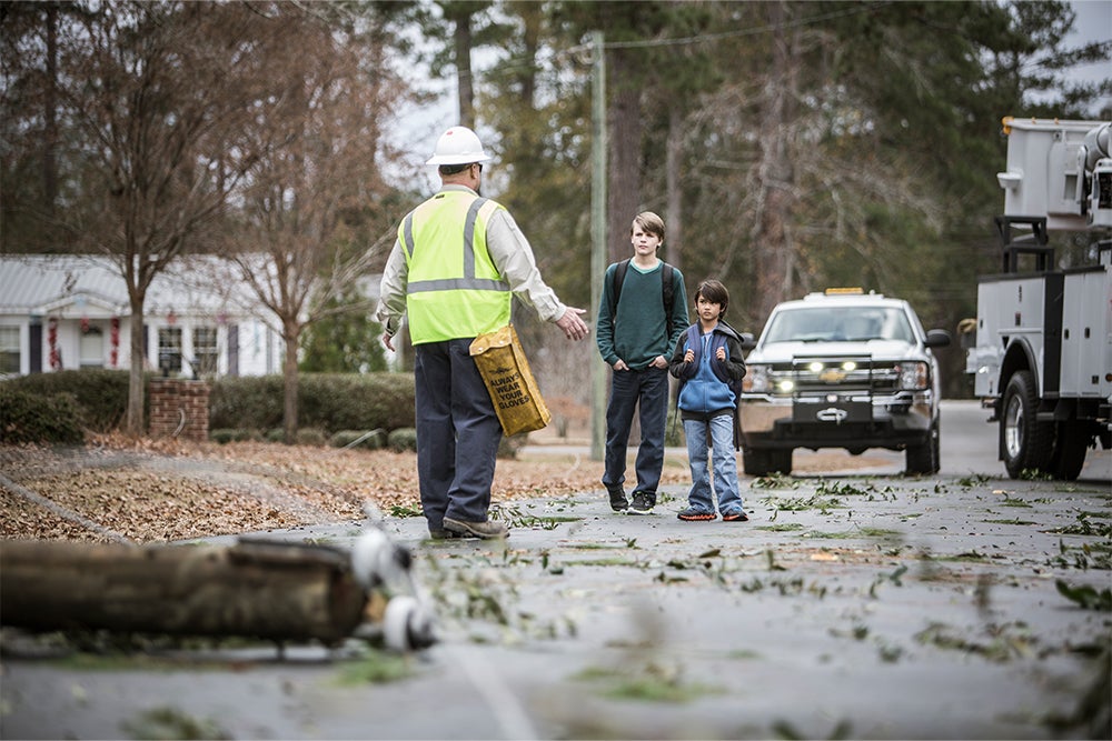 lineman keeps kids away from downed power lines