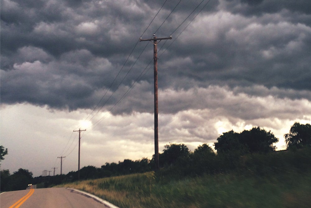 power lines in front of storm clouds